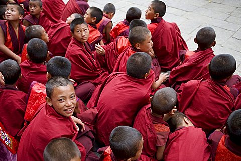 Monks watching religious dances, Buddhist festival (Tsechu), Trashi Chhoe Dzong, Thimphu, Bhutan, Asia