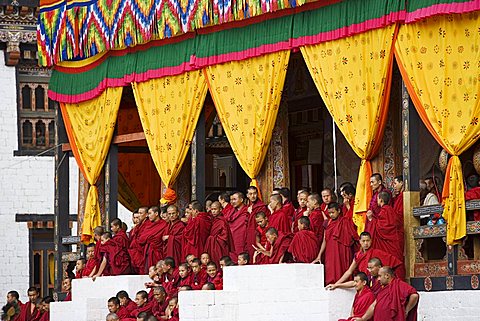 Buddhist monks watching festival (Tsechu), Trashi Chhoe Dzong, Thimphu, Bhutan, Asia