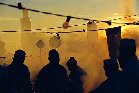 Chefs at food stalls in the evening in the Djemma-el-Fna square, Marrakech, Morocco