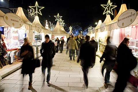 People strolling over Christmas market in the evening, Hamburg, Germany