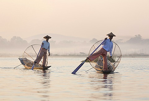 Intha leg rowing fishermen at dawn on Inle Lake, Shan State, Myanmar (Burma), Asia