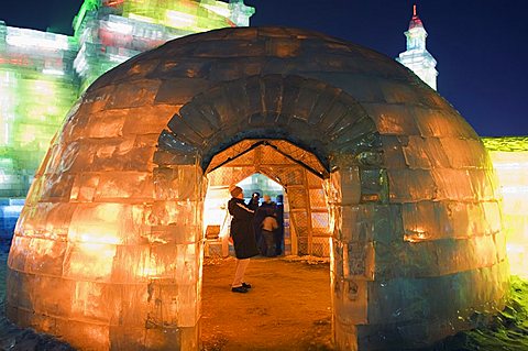 An igloo ice sculpture illuminated at night at the Ice Lantern Festival, Harbin, Heilongjiang Province, Northeast China, China, Asia