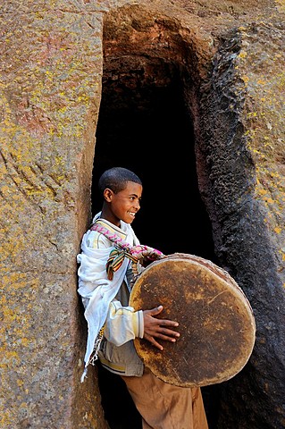 Ethiopia, Lalibela,Timkat festival, Church of Bieta Giyorgis, Young boy beating a drum to mark the return of the Tabots  Every year on january 19, Timkat marks the Ethiopian Orthodox celebration of the Epiphany  The festival reenacts the baptism of J