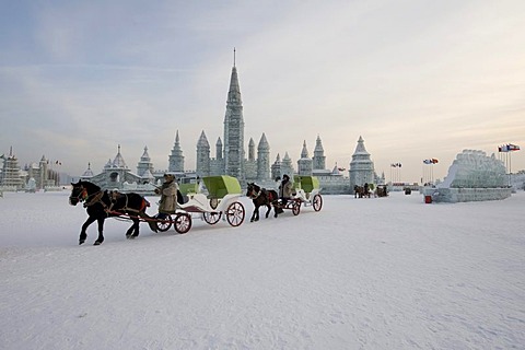 Horse drawn carriages passes an ice castle in Harbin.