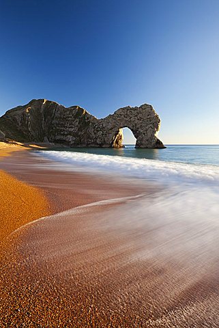 Waves break onto Durdle Door beach, Jurassic Coast, Dorset, England. Winter (January) 2011.