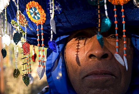 A Chinelo dancer rests on the sidelines of carnival celebrations in Tlayacapan, Mexico, February 5, 2008.  Groups of Chinelos dance the "Brinco del Chinelo," or the "Chinelo Hop" during Carnival. Spanish colonizers brought the tradition of Carnival to the