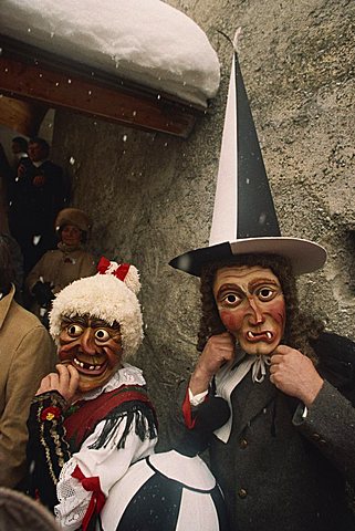 People wearing masks, one with a tall pointed hat, Fasnacht carnival, Imst, Austria, Europe