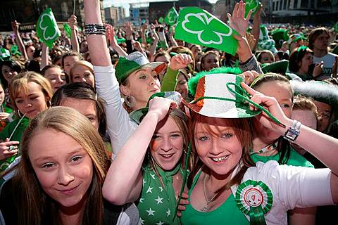 young teenage irish girls at the front of the crowd at the st patricks day concert and carnival in custom house square belfast northern ireland