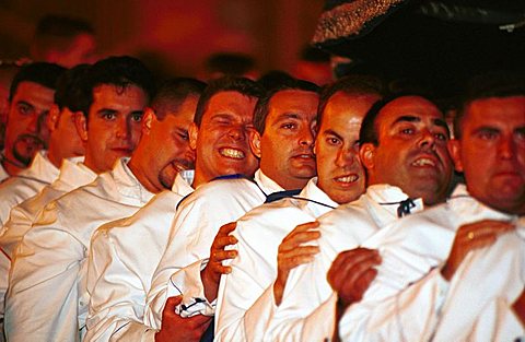 Malaga-Spain - Easter Week (Semana Santa) - Members of a brotherhood strain to carry a float