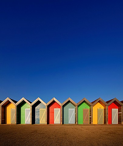 Colourful beach huts along the seafront promenade at Blyth, Northumberland, England