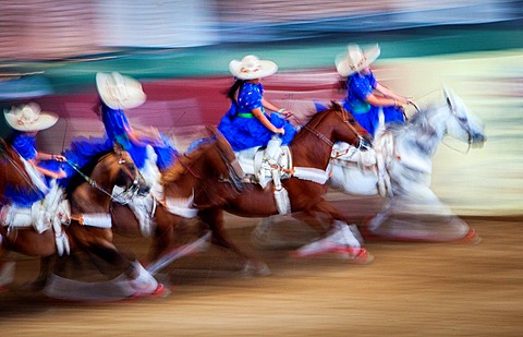 Escaramuzas ride their horses. A charreada Mexican rodeo at the Lienzo Charro Zermeno, Guadalajara, Jalisco, Mexico.