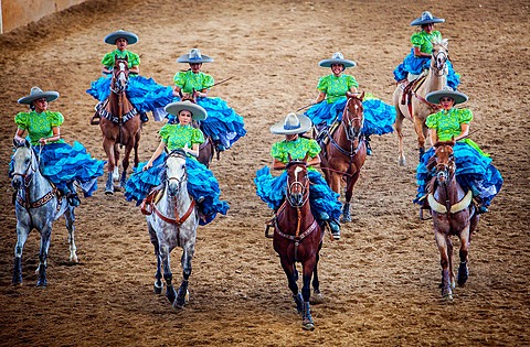 Escaramuzas ride their horses. A charreada Mexican rodeo at the Lienzo Charro Zermeno, Guadalajara, Jalisco, Mexico.