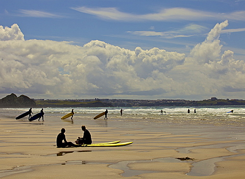 Surfers with boards on Perranporth beach, Cornwall, England, United Kingdom, Europe