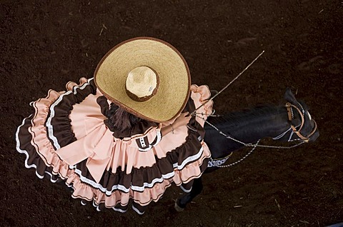 An escaramuza from Anahuac of Tecamac team rides her horse in a rodeo competition in Mexico City, May 10, 2008. Escaramuzas are similar to US rodeos, where female competitors called "Amazonas" wear long skirts, and ride side saddle. Male rodeo competitors