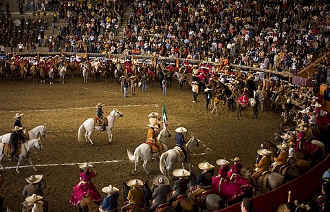 The crowd watches Charros and Amazonas line up in the arena at the start of a Charreria and Ezcaramuza exhibition in Mexico City, June 8, 2008.  Charrerias and Escaramuzas are similar to US rodeos, with male competitors called Charros and female competitor