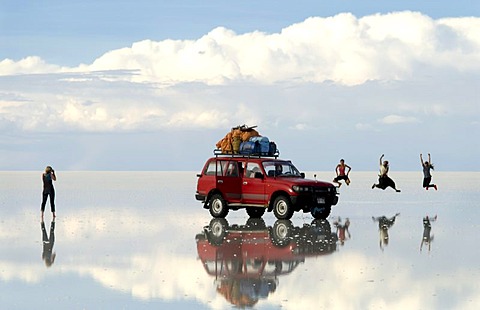 Salar de Uyuni, Bolivia -Tourists jump for joy while posing for a photograph in the middle of the Salar de Uyuni, southern Bolivia's huge salt desert.