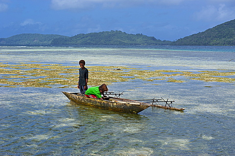 Young boys fishing near Samarai, the old capital, Papua New Guinea, Pacific