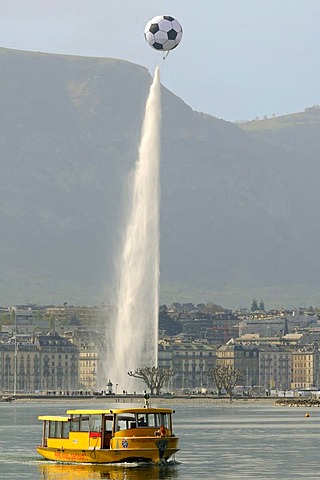 Eurofoot Football symbol hovering above the Jet d'Eau, ferry boat on Lake Geneva, Geneva, Switzerland, Europe