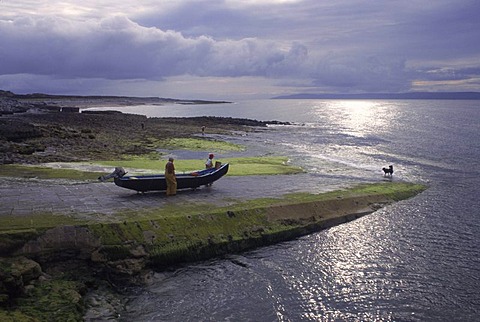 lobster man on ireland irish coast with boat and sea