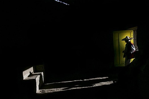 A man enters a room next to the church of San Juan, near Otavalo, Ecuador, during the fiesta of San Juan or "Inti Raymi" on June 25, 2006.  During the fiesta people play music and dance for days.  The fiesta of Inti Raymi sweeps through the northern Andes