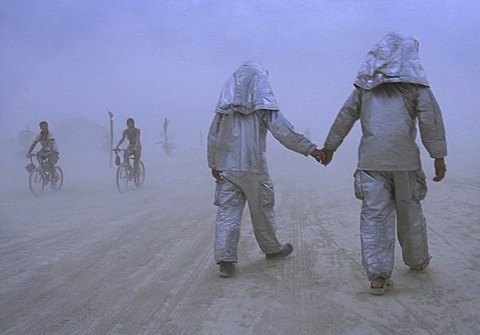 A couple walks through a dust storm at Burning Man in the Black Rock Desert, Nevada on August 30, 2002.  Burning Man is an art festival that celebrates free expression.  In 2002 about 29,000 people attended the festival that started in 1986 when Larry Harv