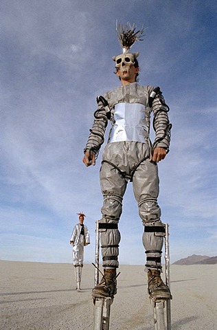 Burning Man, Black Rock Desert, Nevada - August 2000: A man walks on stilts through the Black Rock Desert during the Burning Man Festival.