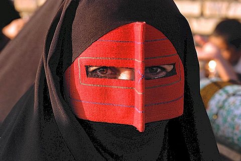 Portrait, iran. A woman with a traditional mask (nakab) in kohestak village, hormogan province. These masks are usually worn by rural women in southern iran. Slight difference in colour or designs of mask can have significant meanings. eg.Red Masks are usu