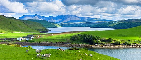 Traditional Scottish farm and loch with backdrop of The Cuillins mountains on the Isle of Skye in the Western Isles of Scotland