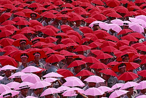 Crowds wearing red and pink umbrella hats during the annual Double Ten National Day in Taipei, Taiwan, Asia