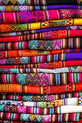 Colourful carpets made of llama and alpaca wool for sale at San Pedro market, Cuzco, Peru, South America