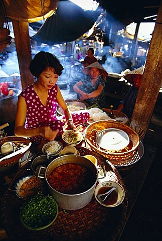 Woman preparing food at a stall in the market, Hoi An, Vietnam, Indochina, Southeast Asia, Asia