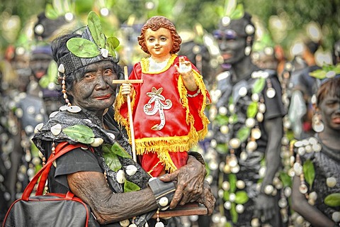 Old woman holding a Santo Nino figur, Ati Atihan festival, Kalibo, Aklan, Panay Island, Visayas, Philippines