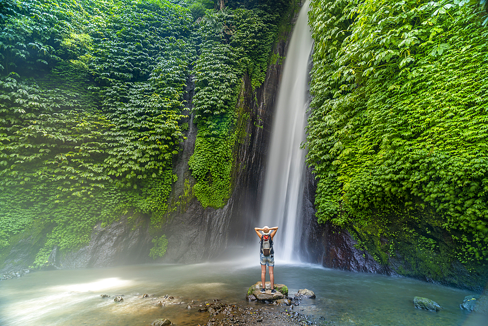 View of a woman taking pictures at Melanting waterfall, Kabupaten Buleleng, Gobleg, Bali, Indonesia, SE Asia